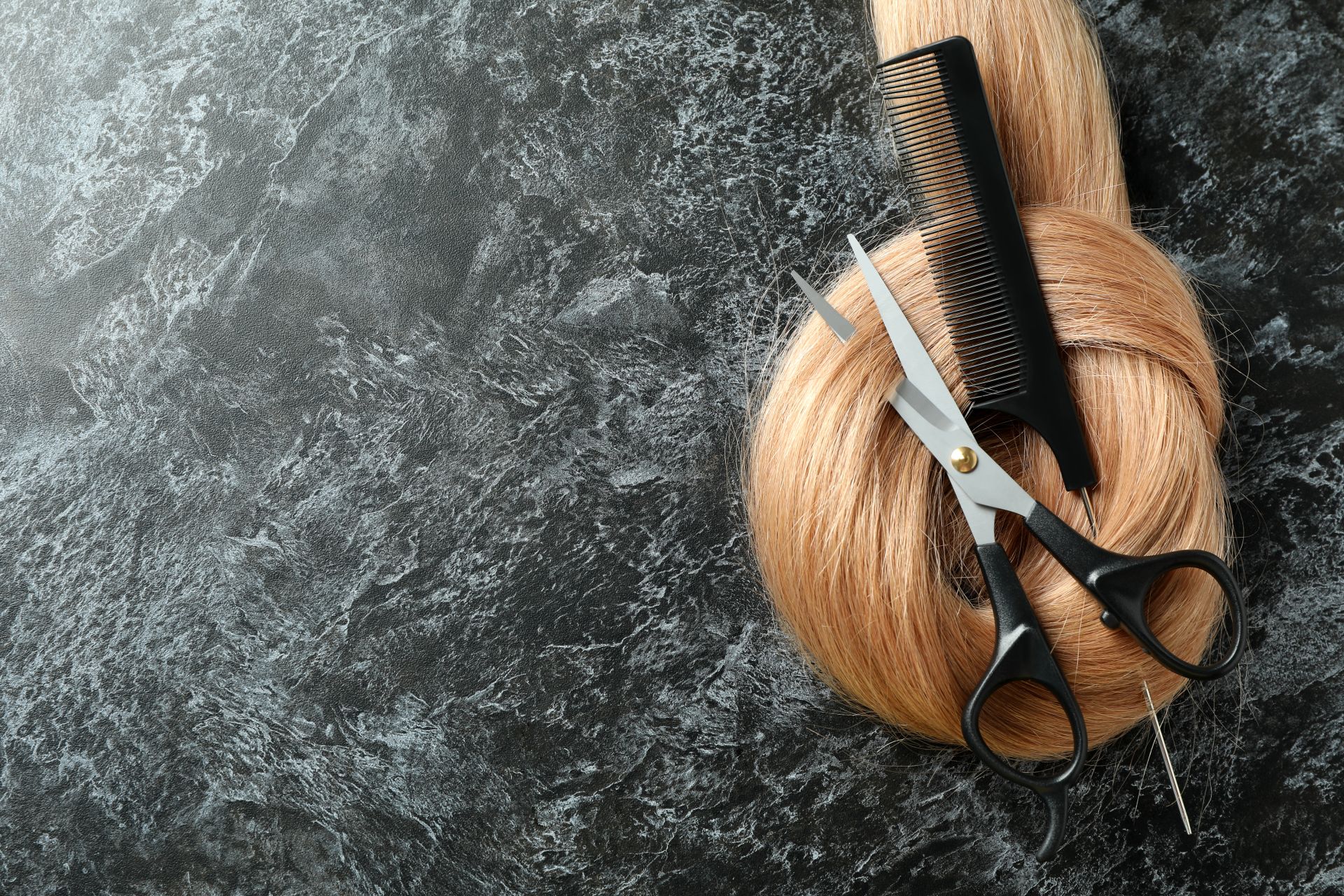 female-hair-with-scissors-hairbrush-dark-background.jpg